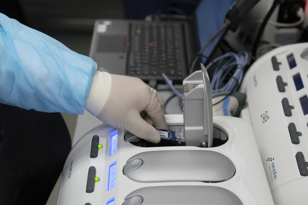 A laboratory technician demonstrates a coronavirus test in Singapore. Photo: Bloomberg