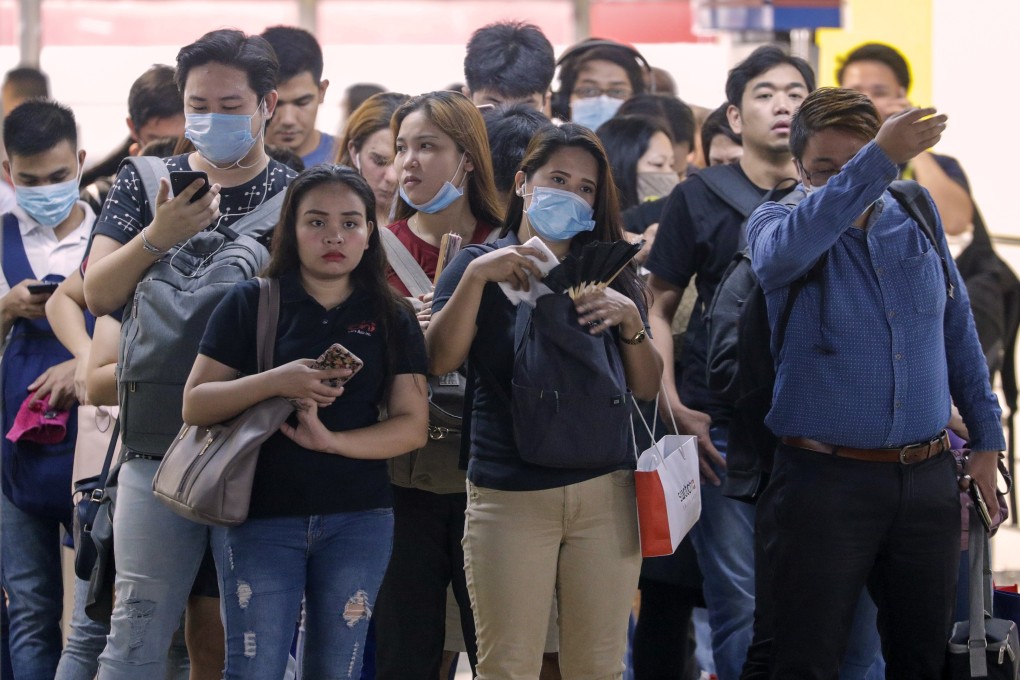 People wear masks as a precautionary measure against the spread of coronavirus in Manila on Tuesday. Photo: AP
