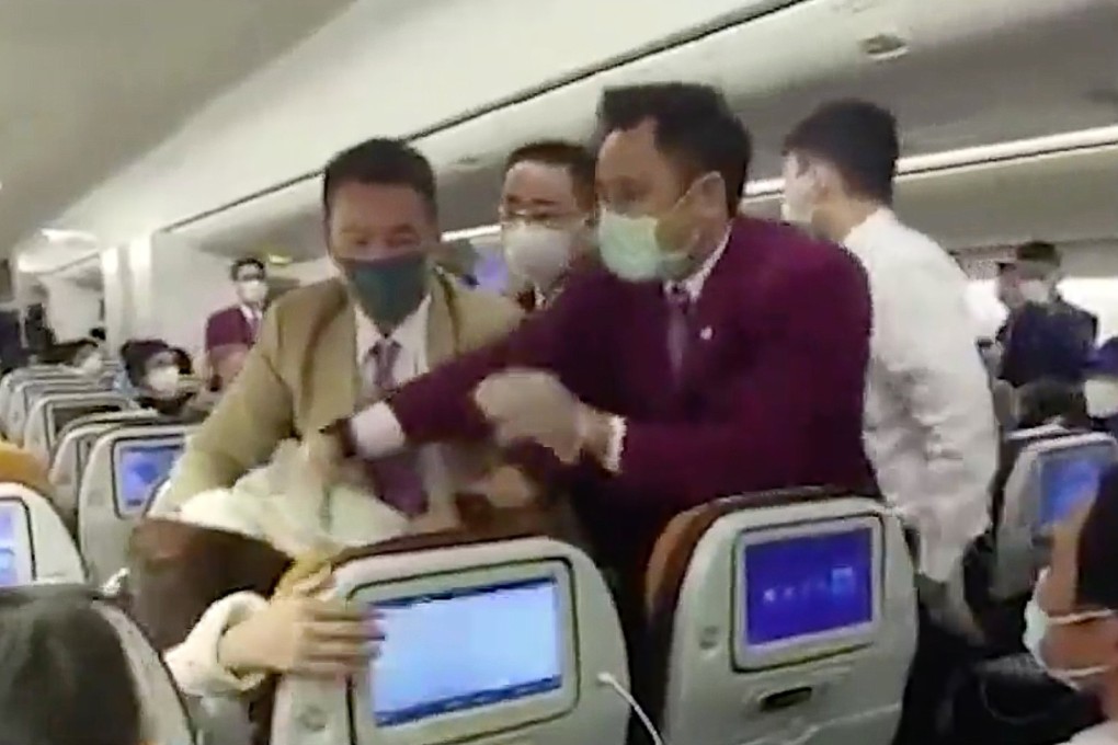 Video taken on board a Thai Airways flight at Shanghai on Friday purports to show flight attendants trying to control a passenger who coughed on one of their colleagues. Photo: Handout