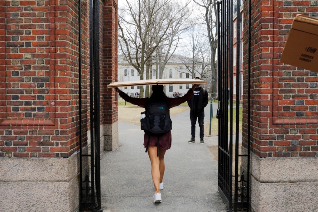 A student carries a box to her dorm at Harvard University on Tuesday, after the school asked its students not to return to campus after spring break. Photo: Reuters