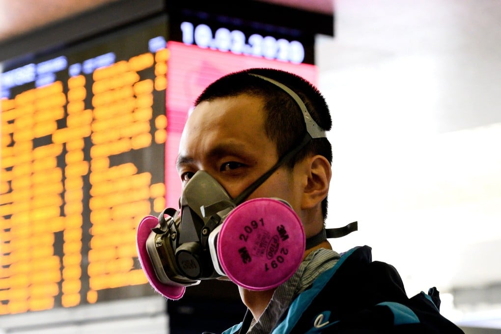 A man wearing a respiratory mask waits at the Termini railway station in Rome . Photo: AFP