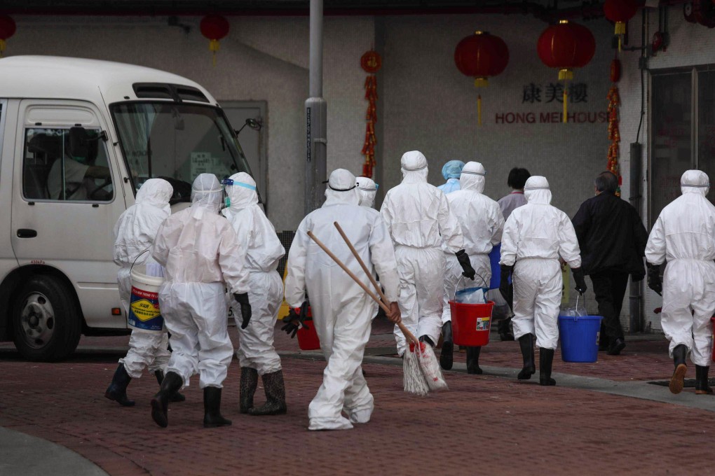 Food and Environmental Hygiene Department staff arrive to clean a public housing block in Tsing Yi on February 12, amid concerns that the coronavirus might have spread through the drainage system. Photo: Xiaomei Chen