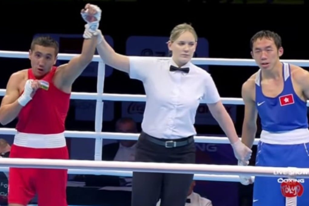 Rex Tso looks dejected as world champion Mirazizbek Mirzakhalilov, of Uzbekistan, is declared the winner in the Asia/Oceania Olympic quarter-final qualifiers in Amman. Photo: Olympic Channel