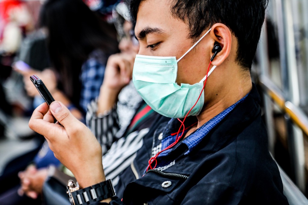 An Indonesian man wears a protective face mask on a public bus in Medan. Photo: EPA