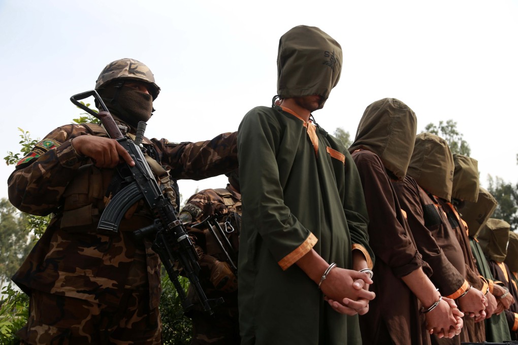 Afghan security officials with a group of suspected militants in Jalalabad, Afghanistan, on Tuesday. Photo: EPA-EFE