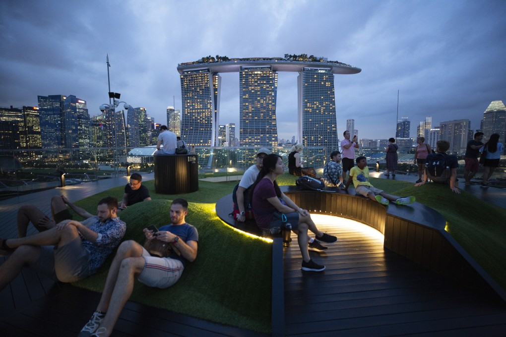 People admire the Singapore skyline from the observatory of the Supertree Grove at Gardens by the Bay. Photo: EPA