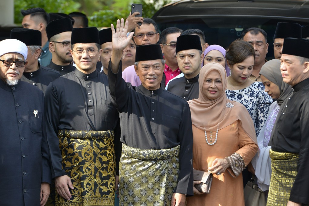Muhyiddin Yassin (centre) waves to supporters as he prepares to be sworn in as Malaysia’s eighth prime minister, in Kuala Lumpur, on March 1. Photo: AP