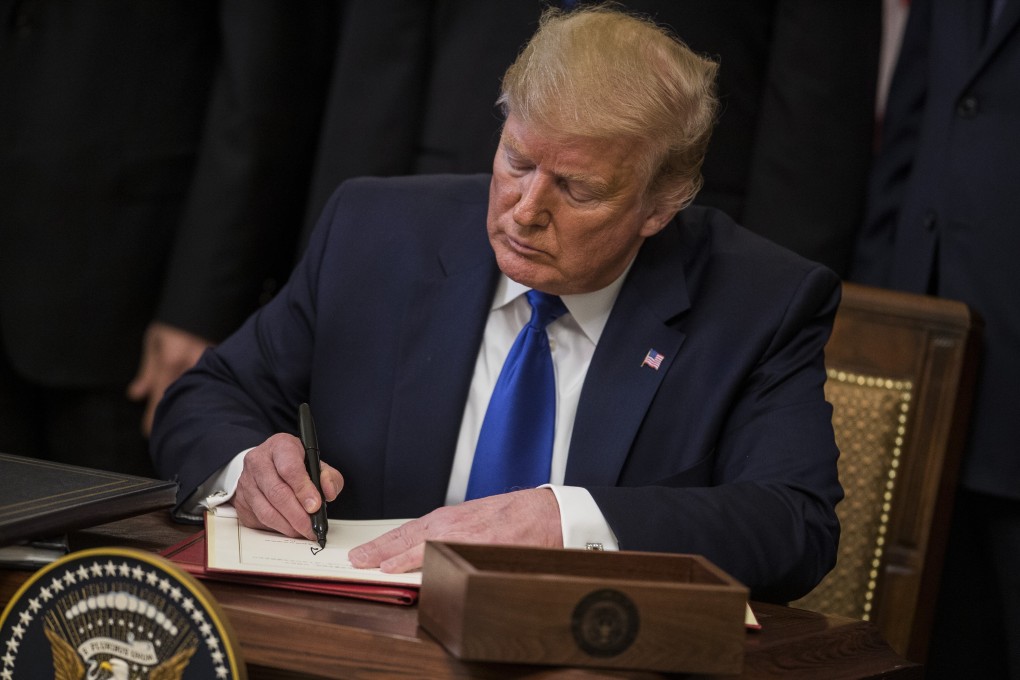 US President Donald Trump signs the US-China phase-one trade agreement during a ceremony in Washington, DC on January 15, 2020. Photo: Bloomberg