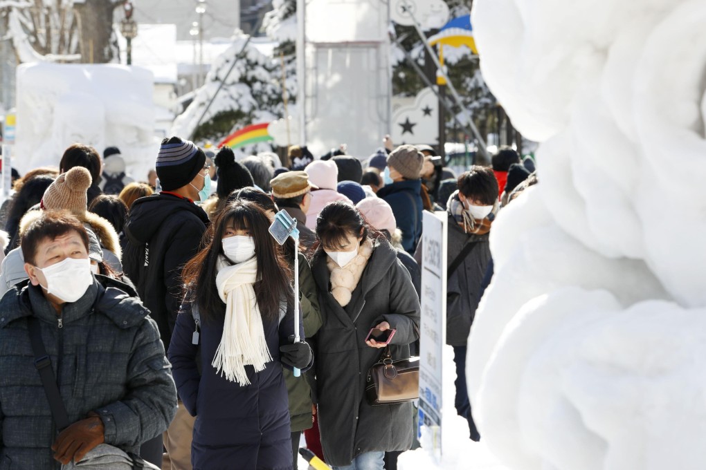 Visitors seen in masks at the annual Sapporo Snow Festival in Hokkaido, on February 4, 2020. Photo: Kyodo