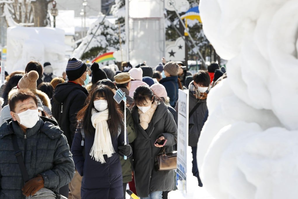 Visitors seen in masks at the annual Sapporo Snow Festival in Hokkaido, on February 4, 2020. Photo: Kyodo