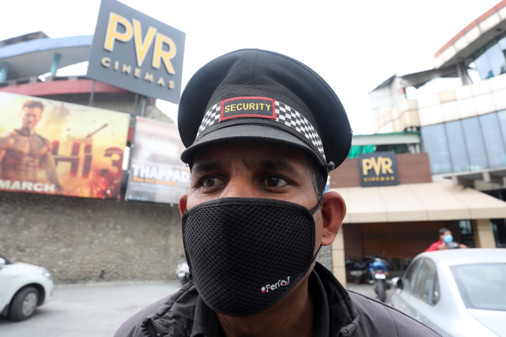 An Indian security guard wears face mask as he stands outside the closed PVR cinema hall in Jammu, India on Wednesday. Photo: EPA-EFE