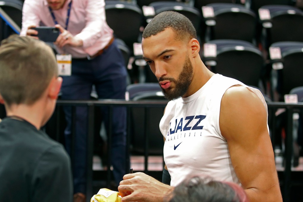 Utah Jazz centre Rudy Gobert signs autographs. The France player is reported to have tested positive for the coronavirus. Photo: AFP