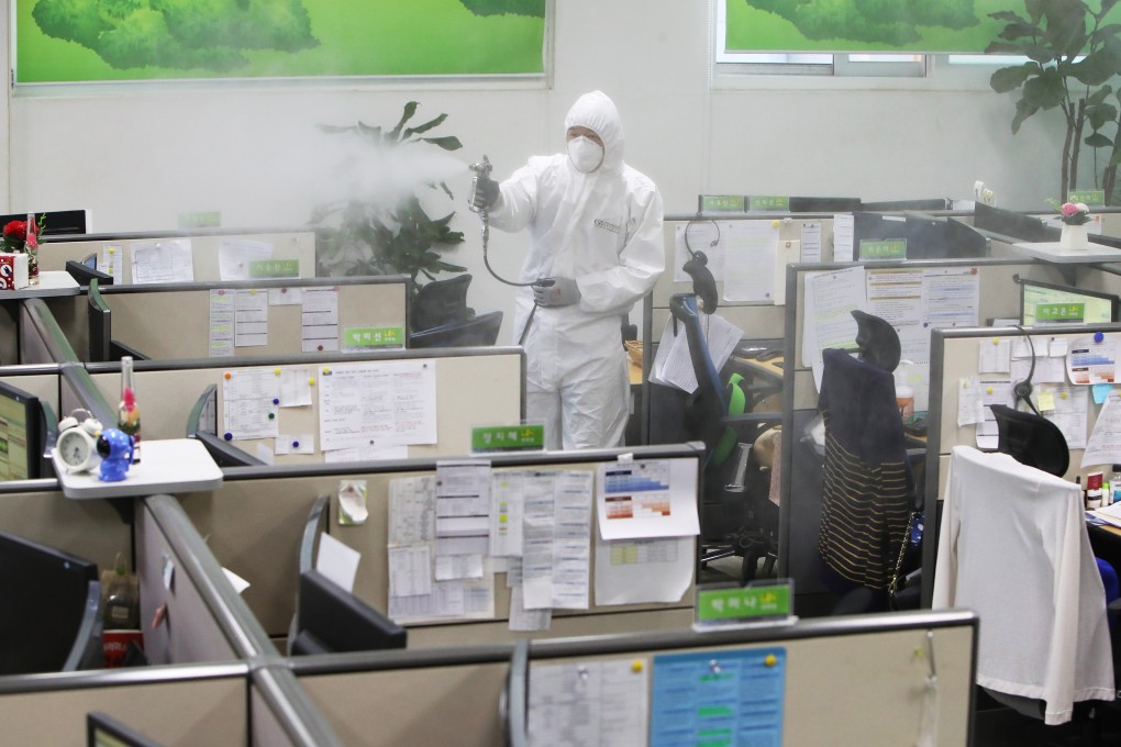 A health worker sterilises a call centre run by the Gyeonggi province government in Suwon. Photo: DPA