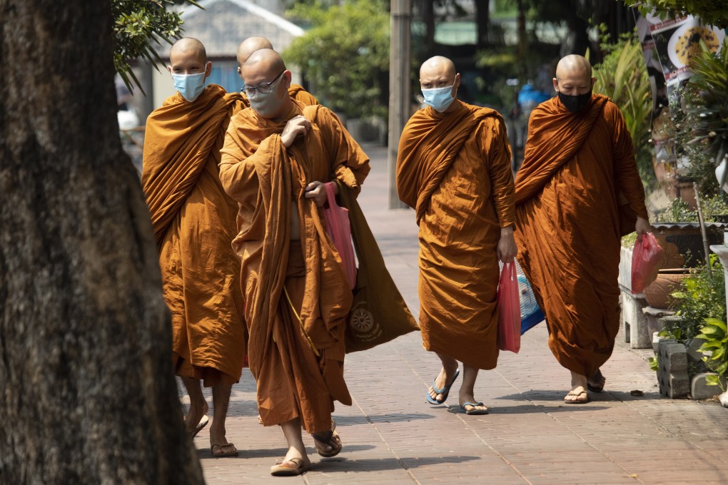 Thai Buddhist monks wear face masks to protect from the coronavirus in Bangkok on Tuesday. Photo: AP