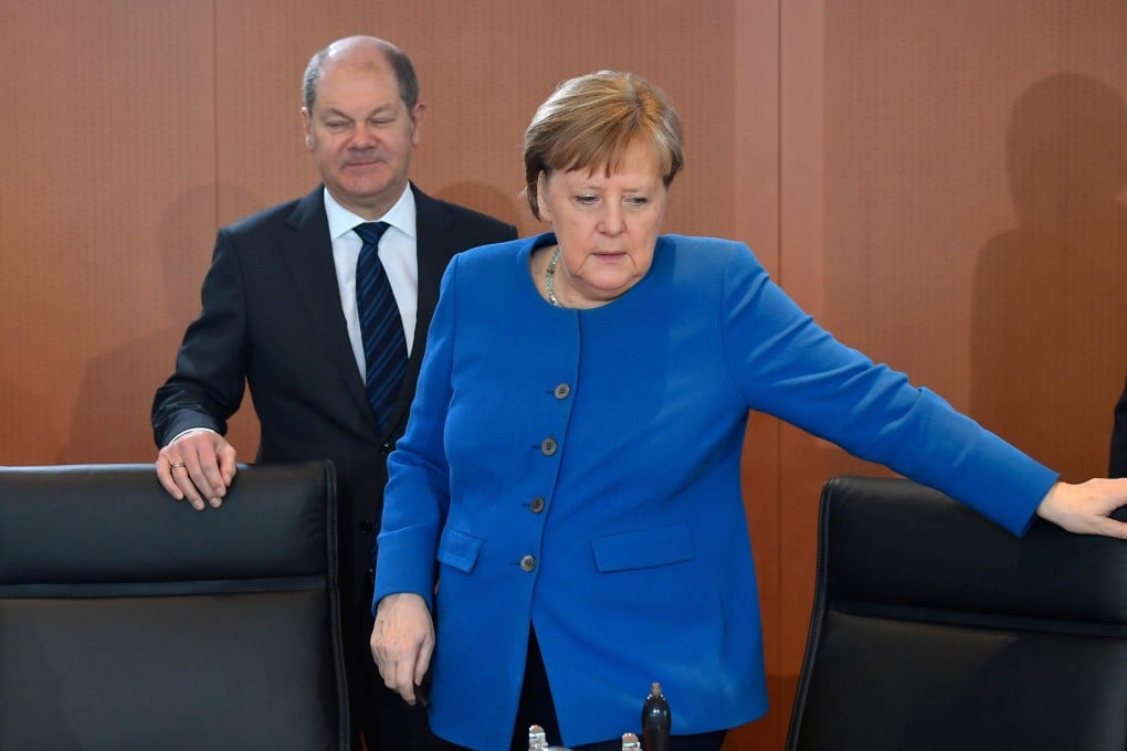 German Chancellor Angela Merkel and Finance Minister Olaf Scholz pulled no punches when talking about the harm the coronavirus outbreak could cause. Photo: AFP