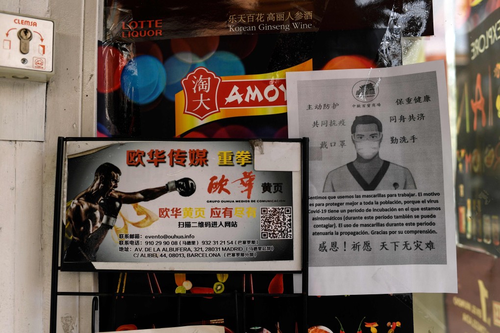 A sign written in Spanish and Chinese offers an apology to customers at a store in Madrid for the use of protective masks in light of the coronavirus outbreak. Photo: AFP