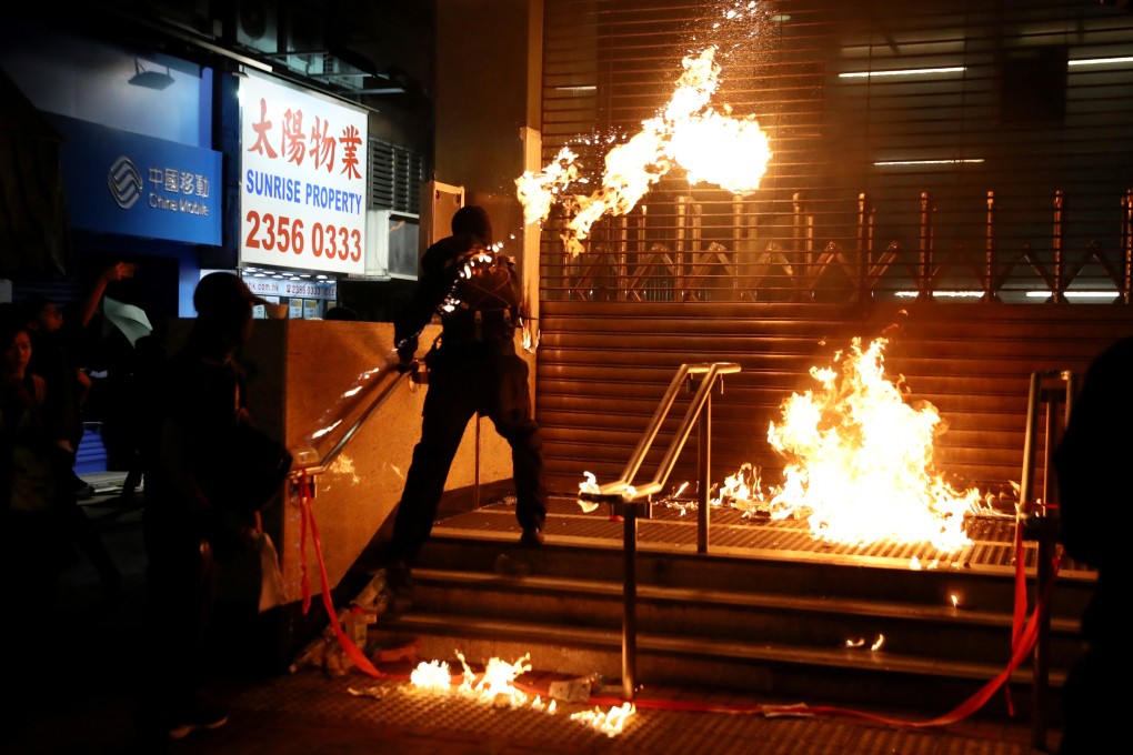 A protester throws a Molotov cocktail at an MTR station in Hung Hom on December 1. Photo: Reuters
