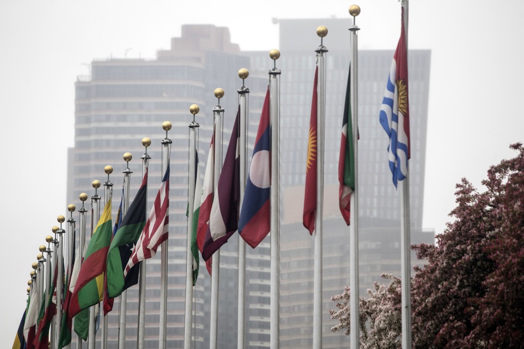 International flags fly outside the Secretariat building of the United Nations headquarters in New York in April 2018. Chinese citizens head four UN organisations. Photo: Bloomberg