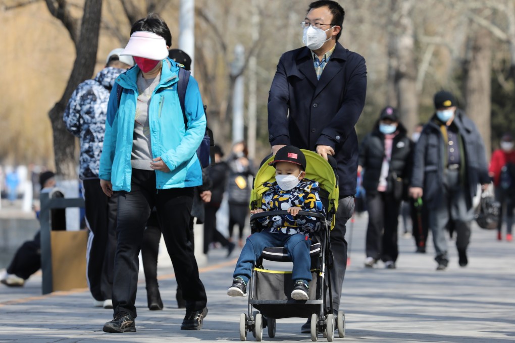 Visitors wear masks at the Summer Palace in Beijing on Wednesday. Park visitors must pre-book, and visitor numbers are capped at 30 per cent of the usual limit. With coronavirus lockdowns lifted, people in China are getting out again, and booking summer trips. Photo: Simon Song