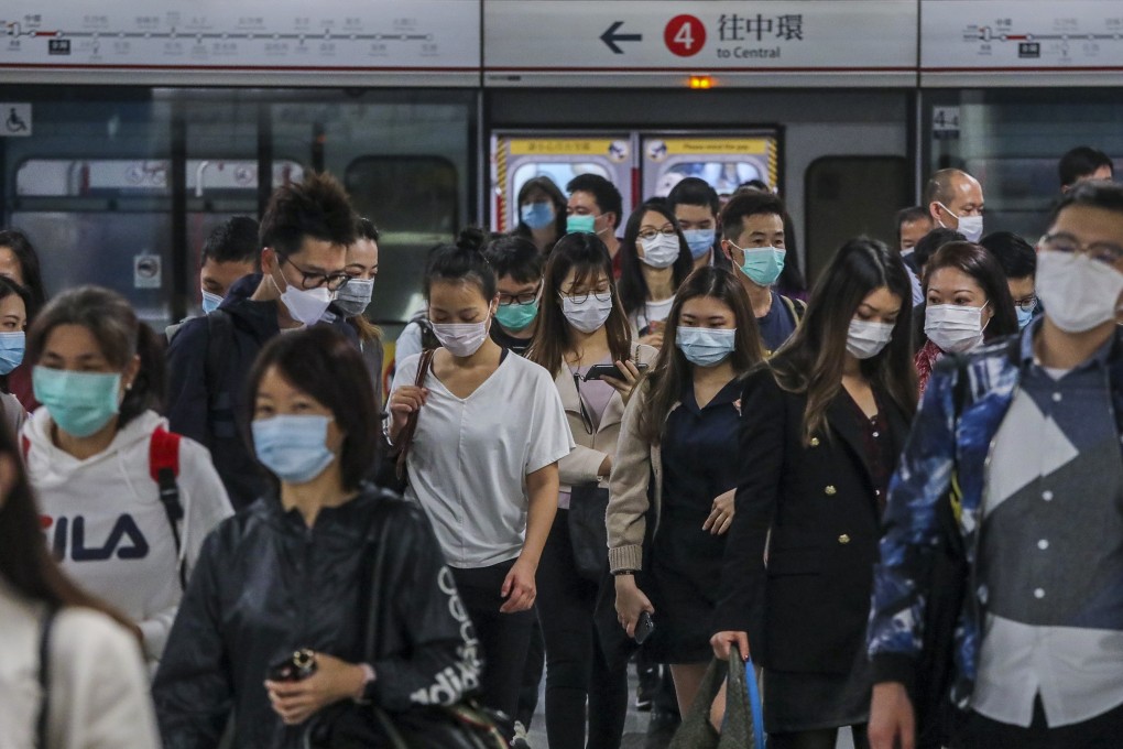 Commuters wearing masks walk through Admiralty MTR station. Photo: Felix Wong