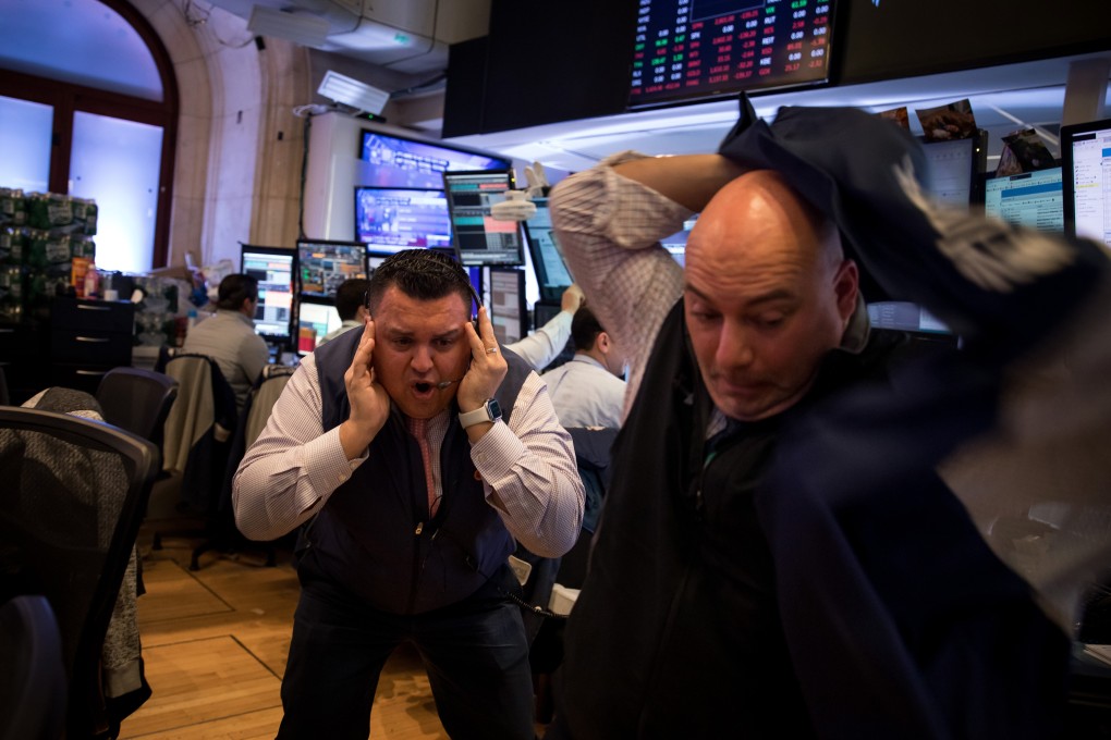 Traders working on the floor of the New York Stock Exchange react as the rout in global stocks deepened on Thursday after investors showed a lack of faith in the US and European policy responses to the worsening spread of the coronavirus. Photo: Bloomberg