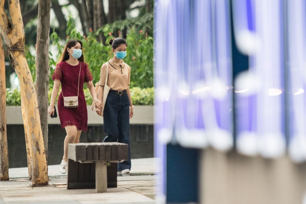 Women wear face masks in Singapore’s Orchard Road shopping district. Photo: AFP
