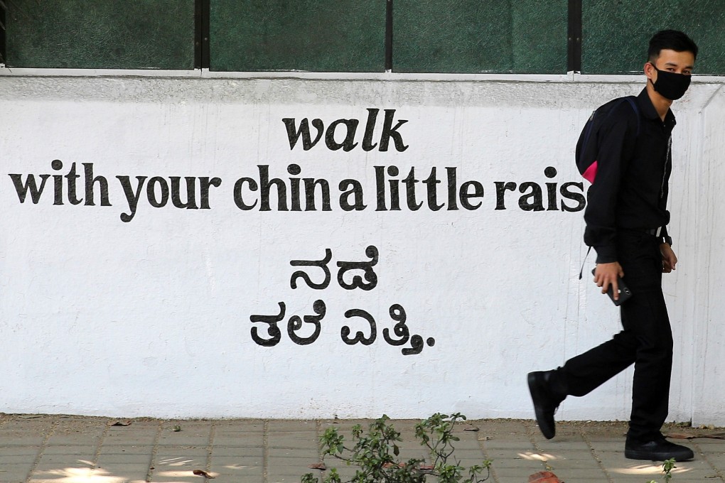 A person wears protective mask as he walks in front of the closed shopping centre in Bangalore, India. Photo: EPA