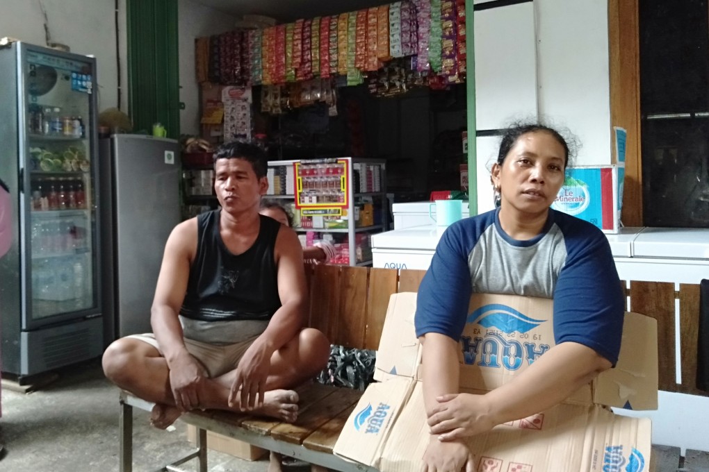 Hasib, 40, and his wife Khomsiah, 38, in front of their shop. Photo: Muhammad Rusmadi