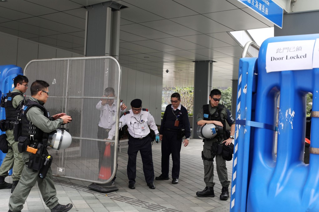 Riot police in front of water barriers at the heavily guarded government headquarters in Tamar. Photo: Xiaomei Chen