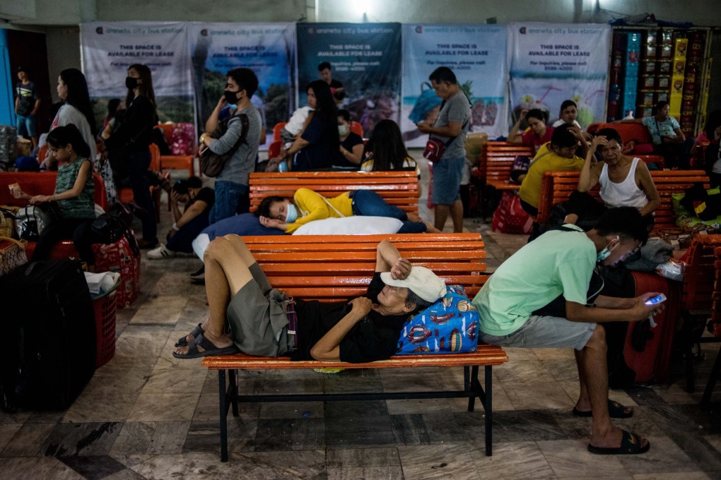 Travellers wait for a bus in a terminal before the lockdown in Manila for 30 days in a bid to halt the spread of the coronavirus. Photo: DPA