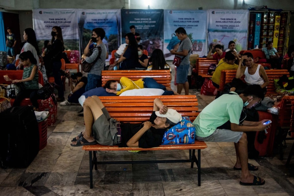 Travellers wait for a bus in a terminal before the lockdown in Manila for 30 days in a bid to halt the spread of the coronavirus. Photo: DPA