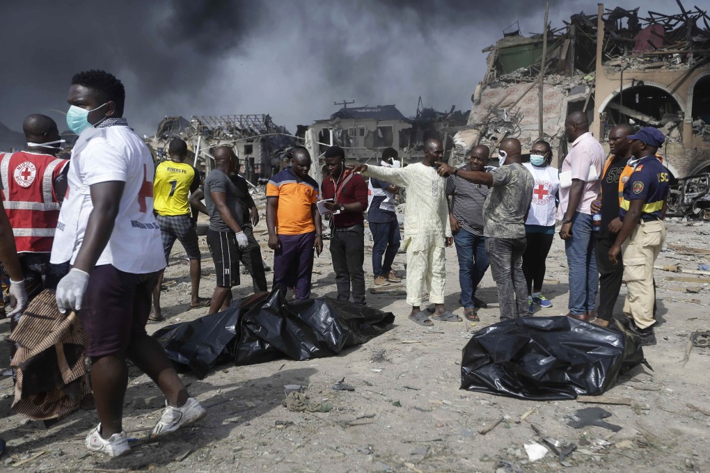 People gather near the site of an explosion in Lagos. Photo: AP Photo