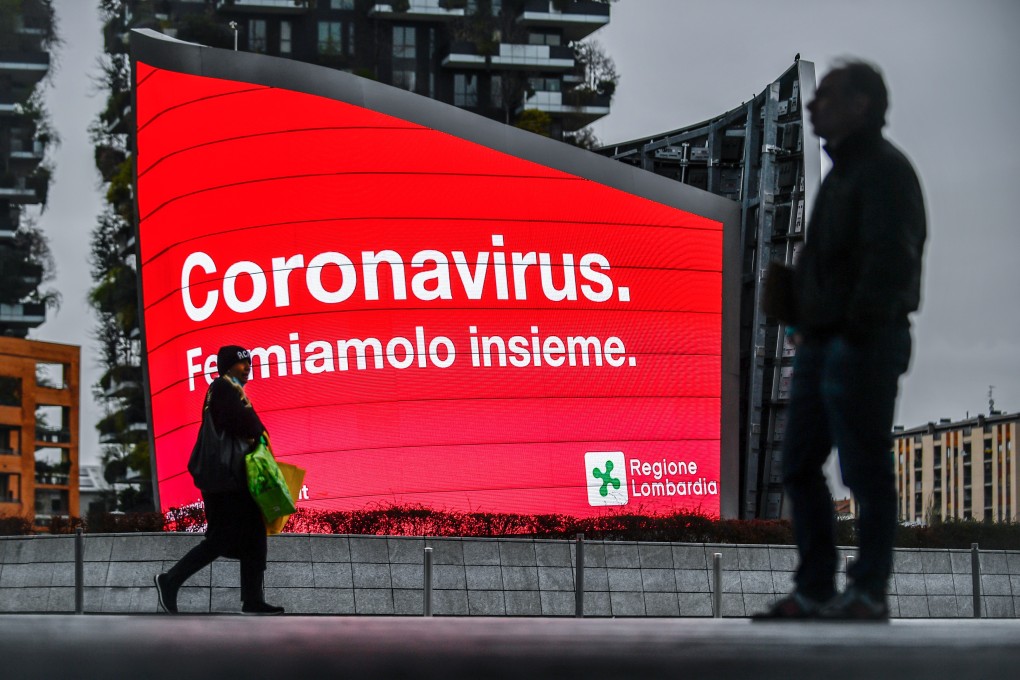 A sign calls for a concerted effort against the novel coronavirus on a near-empty street in Milan, Italy, amid a nationwide lockdown over a deadly Covid-19 outbreak. Photo: LaPresse via ZUMA Press/dpa
