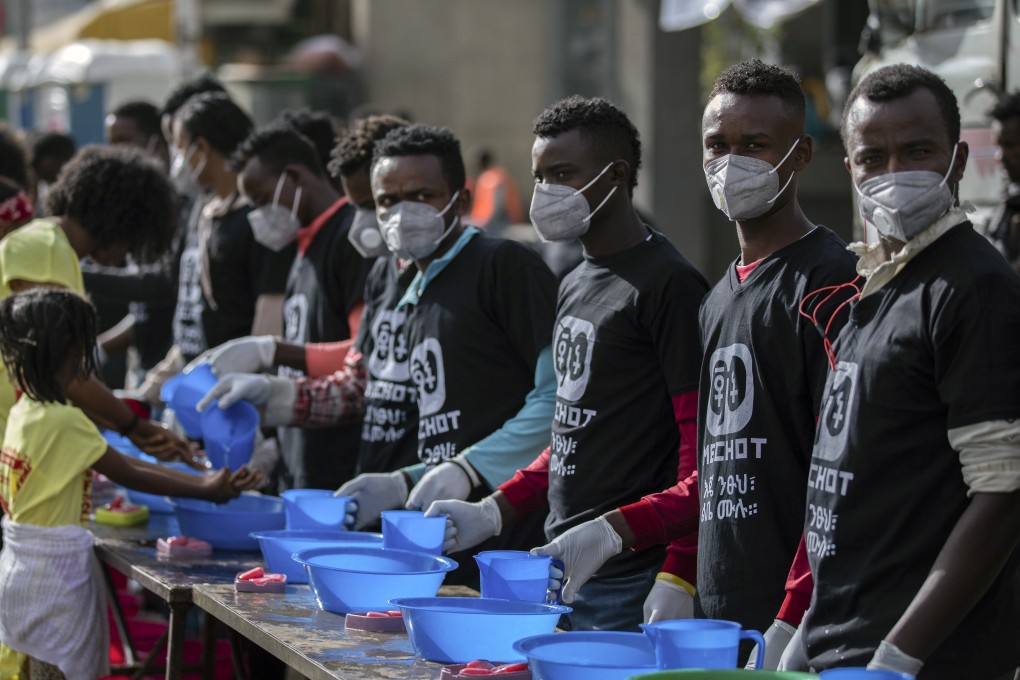 Masked volunteers provide soap and water for participants to wash their hands against the new coronavirus at a women’s 5km fun run in Addis Ababa, Ethiopia on Sunday. Photo: AP
