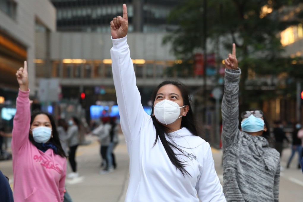 Domestic helpers don masks as they socialise in Central on their day off, but some have told a survey they cannot rely on their employers to issue them with the products. Photo: Nora Tam