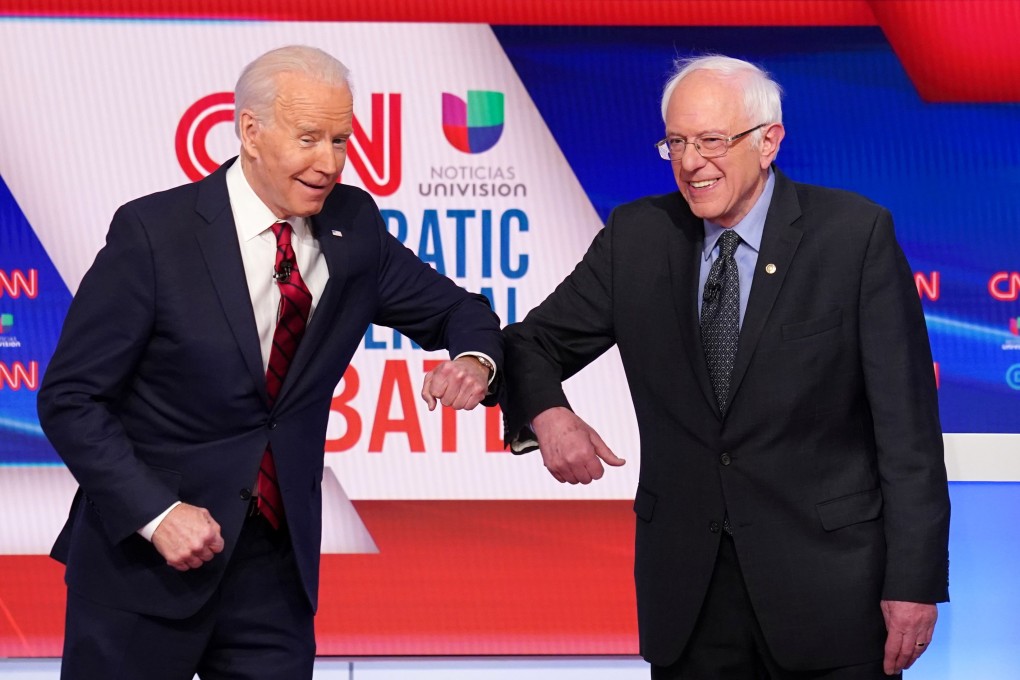 Democratic US presidential candidates Joe Biden and Senator Bernie Sanders do an elbow bump in place of a handshake. Photo: Reuters