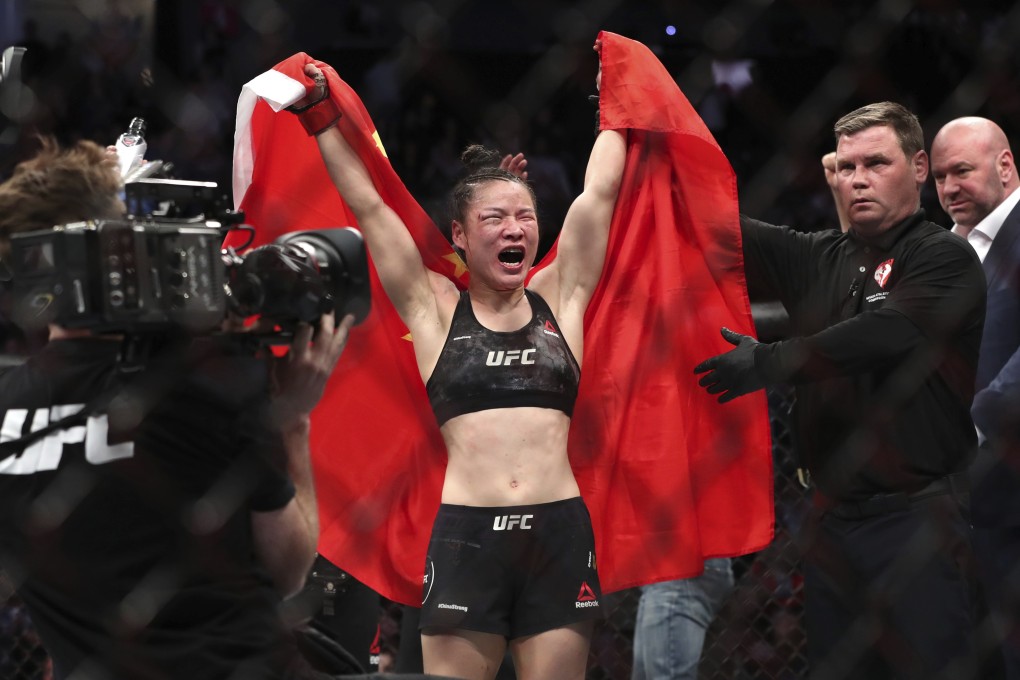 UFC women's strawweight champion Zhang Weili of China celebrates her split decision victory over former champion Joanna Jedrzejczyk at UFC 248. Photo: AP