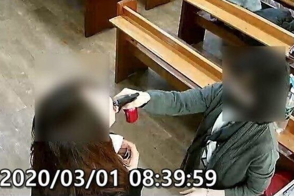 A photo provided by the Gyeonggi Province spokesman’s office shows an official spraying salt water into the mouth of a believer. Photo: Handout