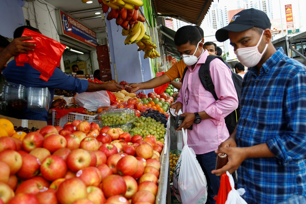 People shop for groceries in Singapore on February 23, 2020. Photo: Reuters