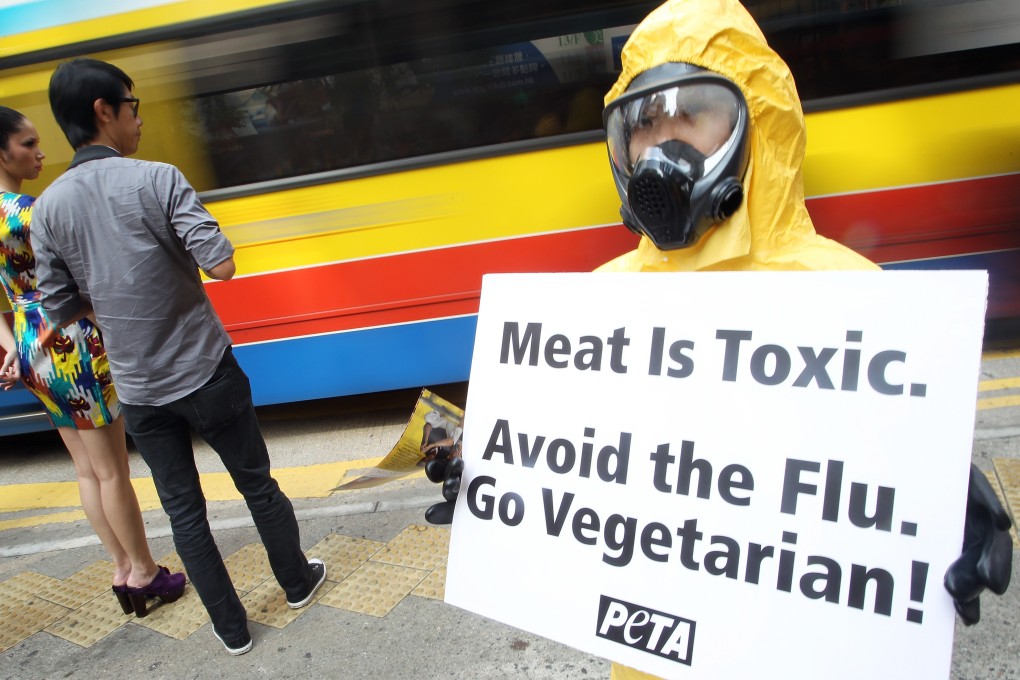 An activist from People for the Ethical Treatment of Animals (PETA) wears a hazmat suit to warn of the health risks of eating meat, at a protest in November 2010 in Hong Kong. Photo: Handout