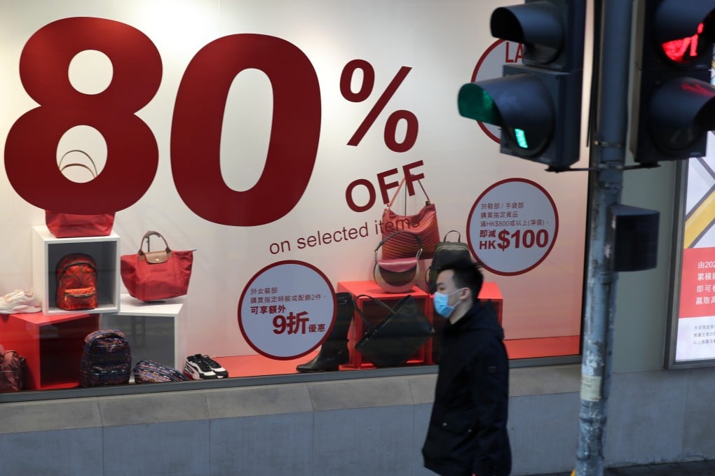 Hong Kong’s ties to global markets leave it vulnerable to the looming global downturn. Pictured, a pedestrian in front of a shop in the Central district. Photo: Xinhua