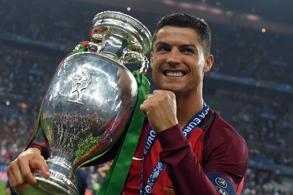 Portugal’s forward Cristiano Ronaldo smiles with the trophy after Portugal won the Euro 2016 final against France. Photo: AFP