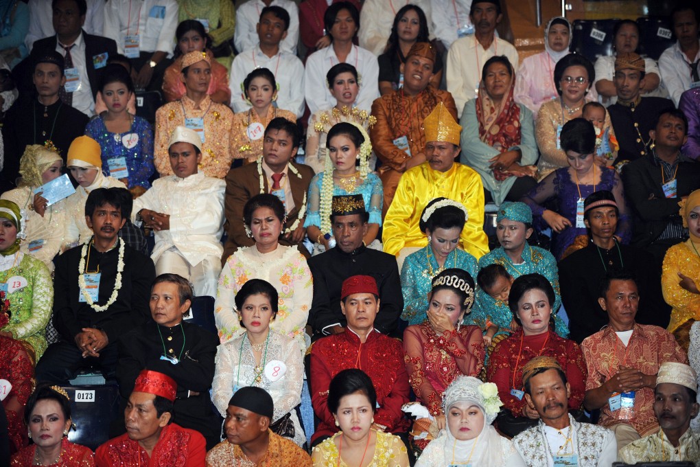 Indonesian couples wearing traditional outfits attend a mass interfaith wedding ceremony sponsored by the Jakarta government in Jakarta, Indonesia in 2011. Interfaith marriages are generally discouraged in the country. Photo: AFP