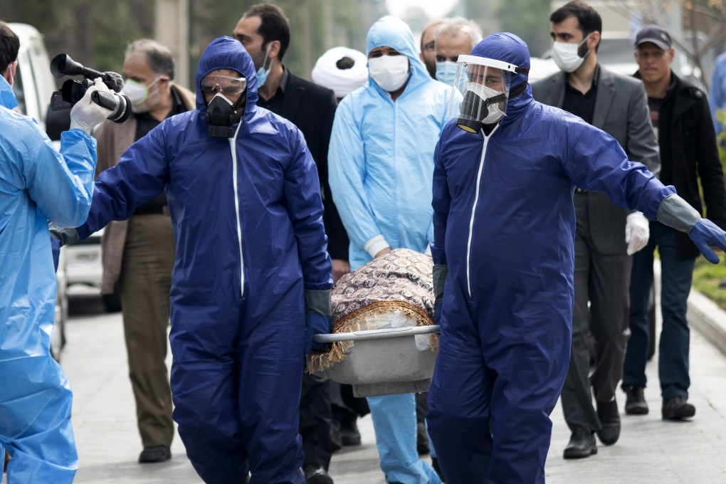 Men wearing protective gear carry the body of Fatemeh Rahbar, a lawmaker-elect from Tehran constituency, who died on Saturday after being infected with the new coronavirus. Photo: AP
