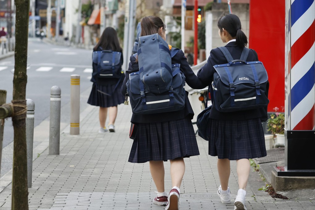 Students walk home from secondary school in Tokyo in February. Pressure to succeed academically has been given as a cause of juvenile suicide. Photo: Kyodo