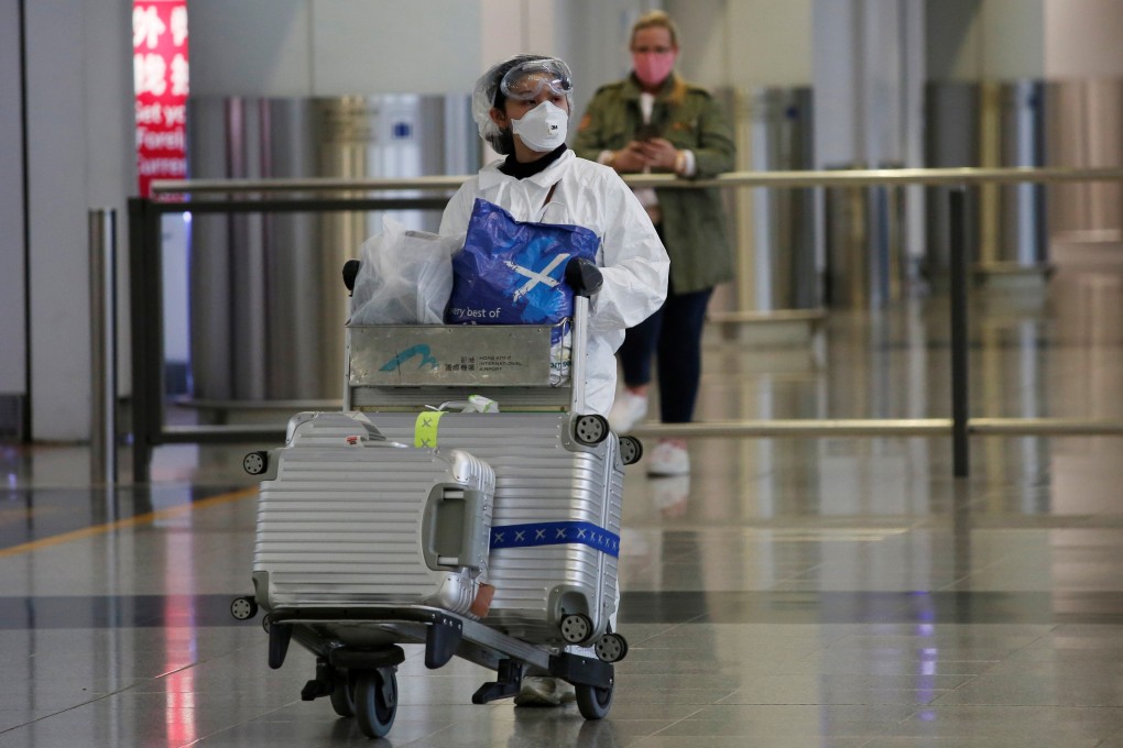 A passenger in protective suit arrives in Hong Kong, as travellers take extra precautions following the outbreak of the new Covid-19 coronavirus. Photo: Reuters