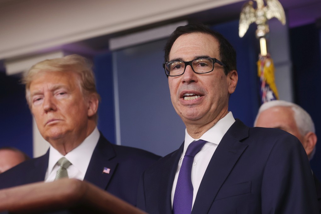 US President Donald Trump looks on as Treasury Secretary Steven Mnuchin explains elements of the stimulus package at the White House on Tuesday. Photo: Reuters