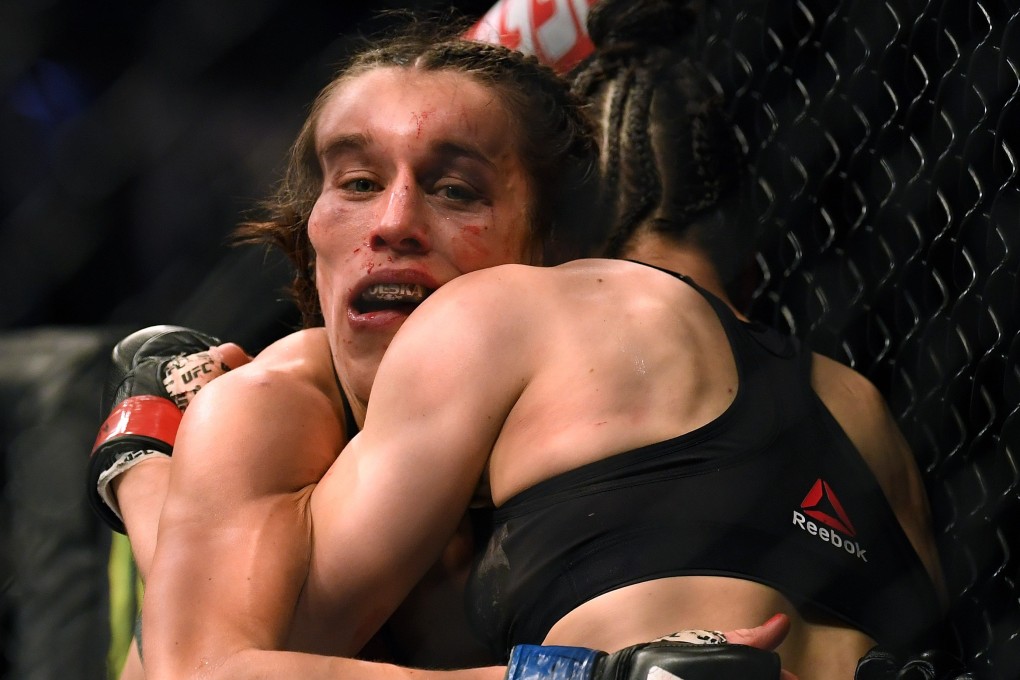 Joanna Jedrzejczyk hangs on to Zhang Weili in a split decision loss at UFC 248. Photo: AFP