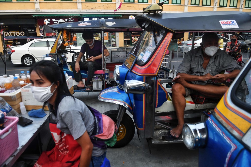 Tuk tuk drivers wear face masks amid concerns over the spread of the coronavirus as they wait for customers on Khao San Road, a popular tourist destination in Bangkok. Photo: AFP