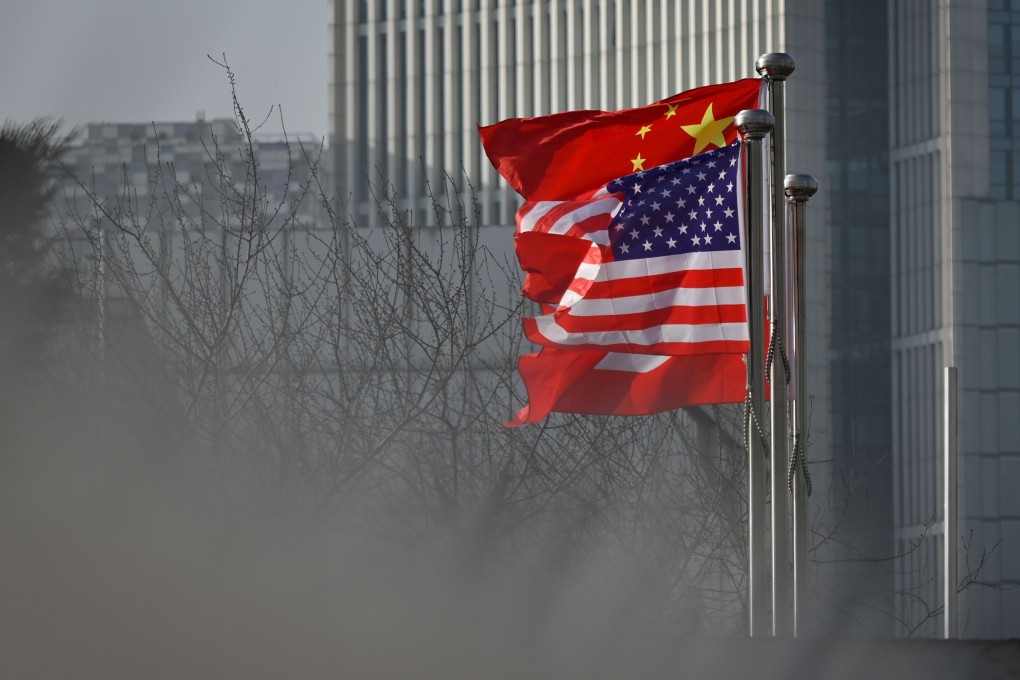 Chinese and US national flags flutter at the entrance of a company office building in Beijing. Photo: AFP